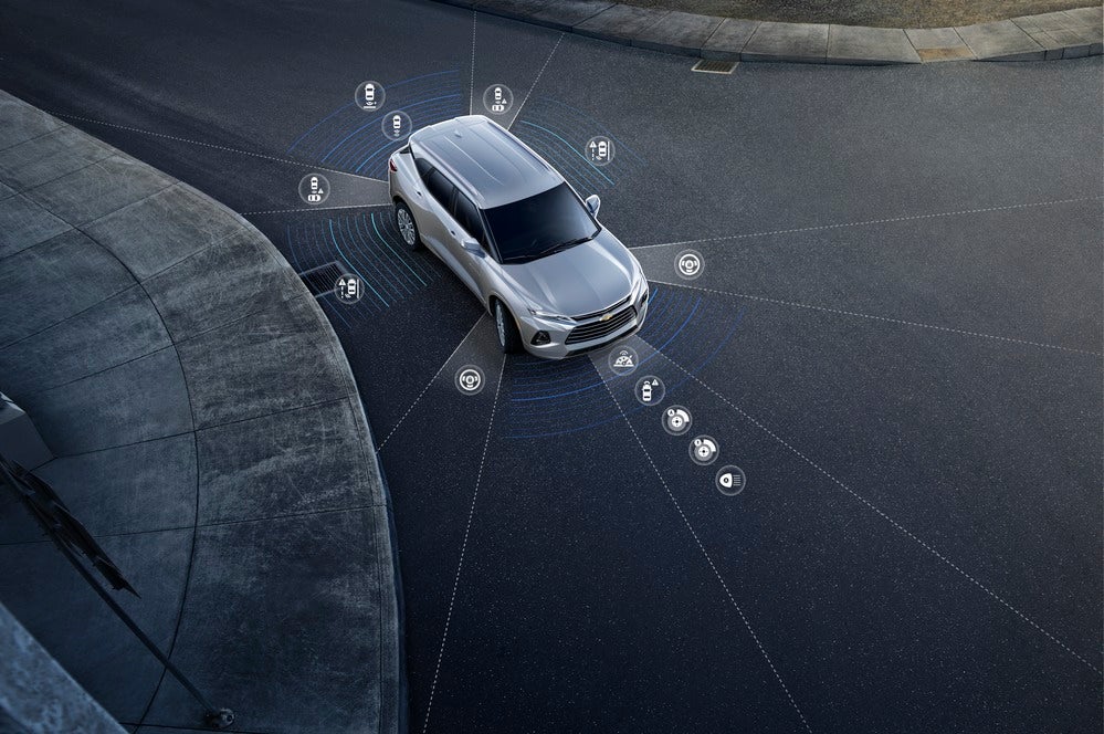 Chevrolet Blazer parked on road with icons dispalying safety features.