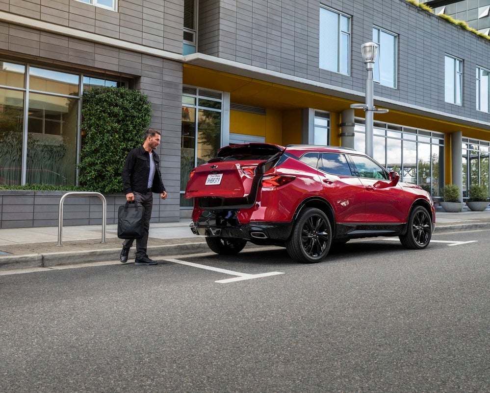 Man opening a tailgate remotely on a 2020 Chevy Blazer.